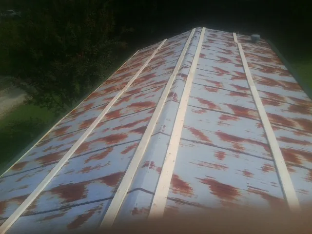 Rusted metal roof panels with new wood purlins before replacement — Storm Damage Roof Repair in Hiko by Roofing Brothers